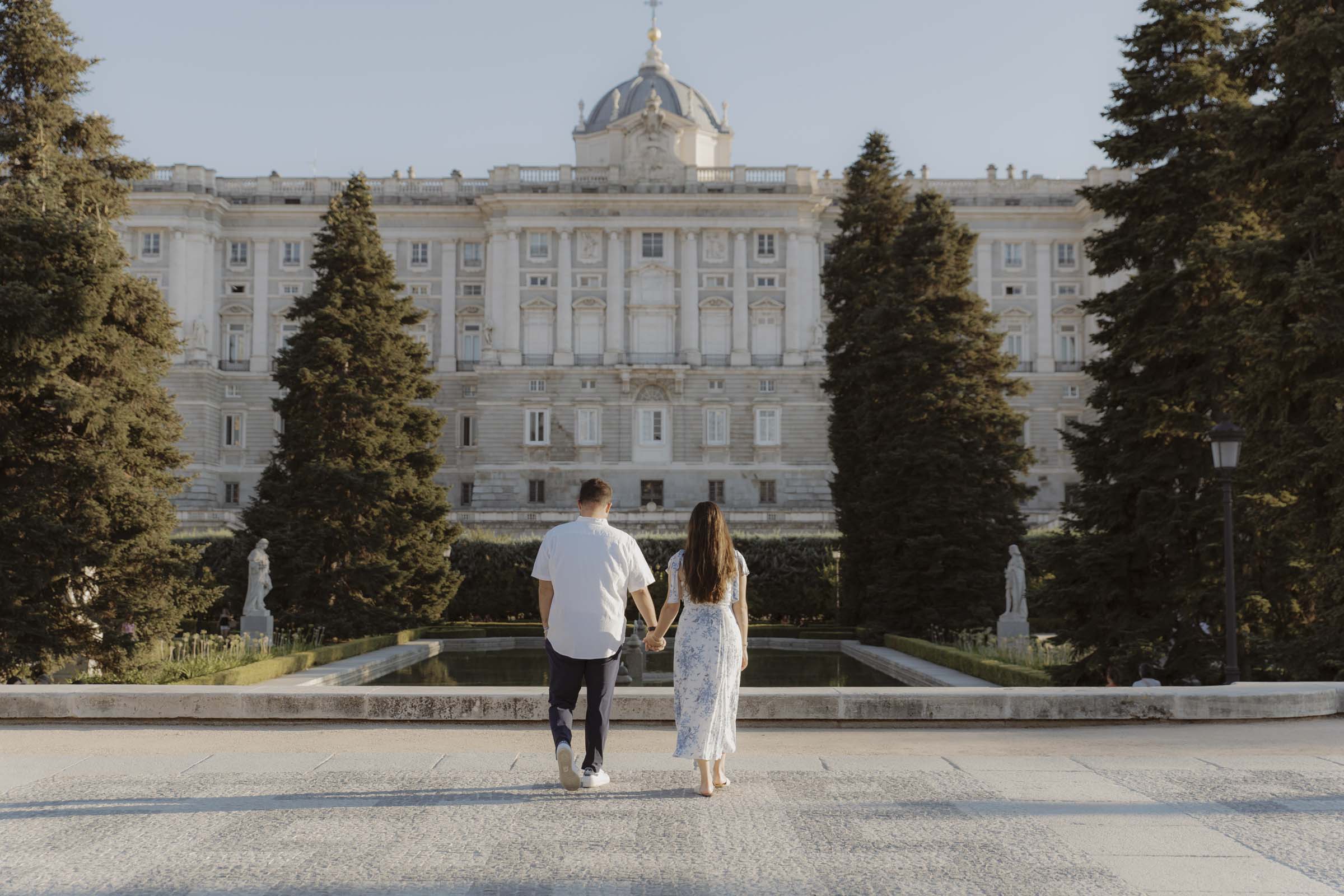 Couple walking in Plaza de Oriente after proposal