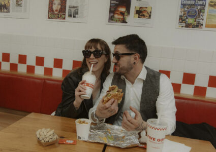 engagement photoshoot at the Five guys in Madrid, with their wedding outfits eating a milkshake and burgers!