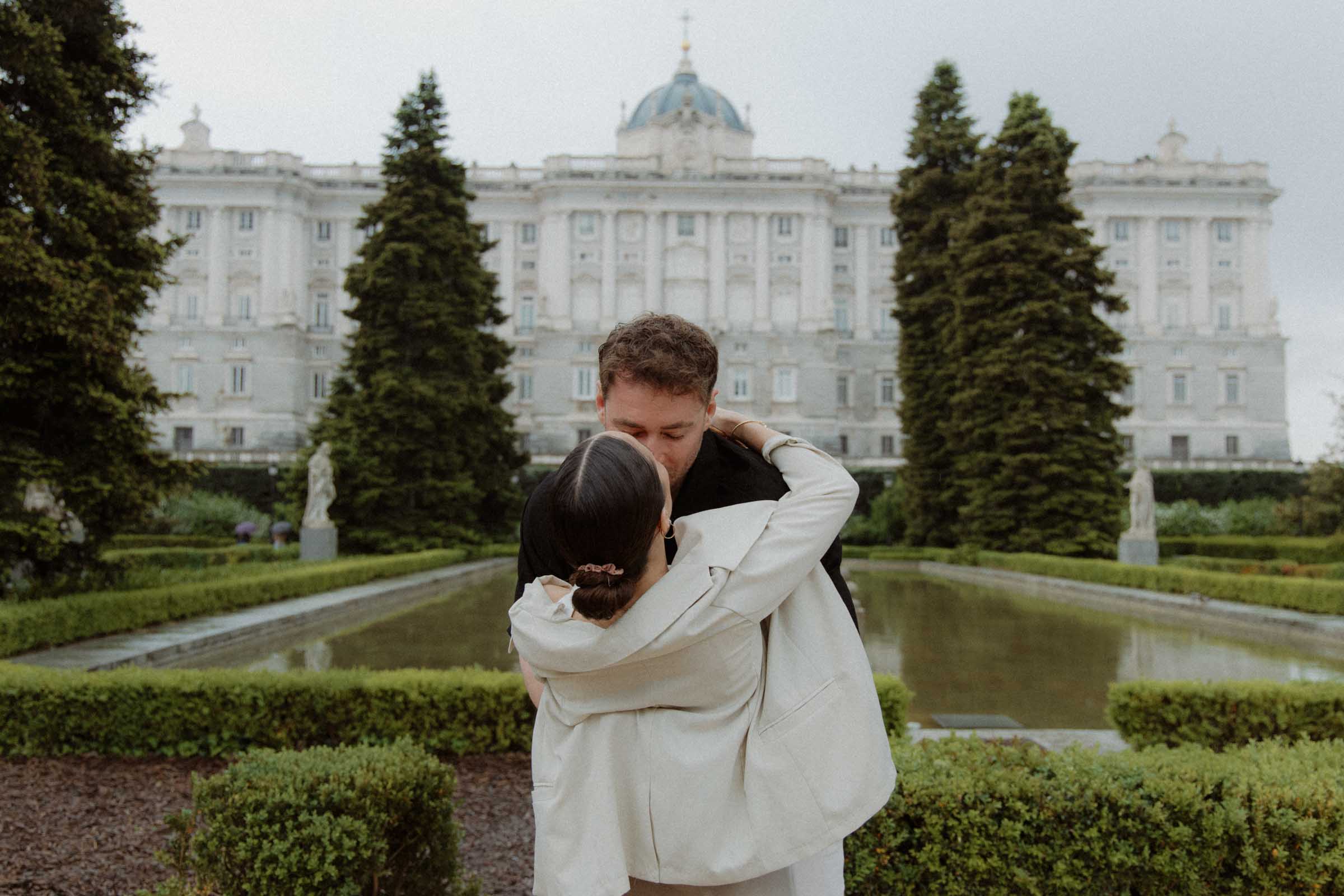 Romantic proposal in Madrid with light rain and natural emotions